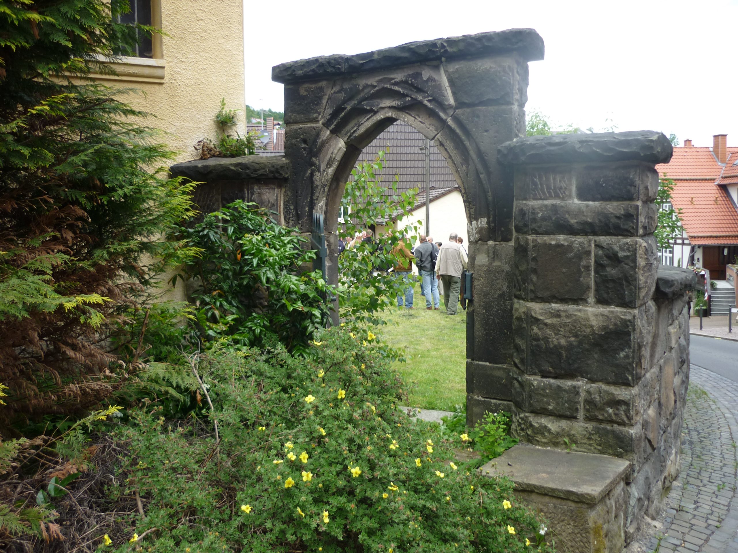 Kleines spätgotisches Spitzbogenportal in der historischen Kirchhofsmauer Großalmerode